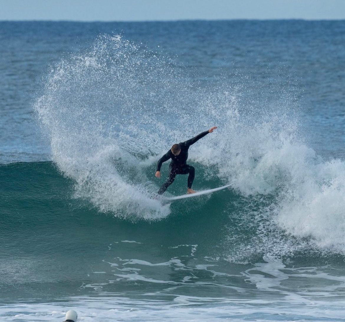 Founder of Core Surf Academy surfing a wave